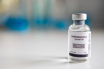 Close-up on Laboratory Tube Virus corona covid 19 vaccine. Scientist research for new novel corona virus immunization drug concept. Coronavirus COVID-19 vaccine vial and injection syringe.