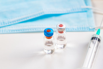 close up on vaccine and medical syringe