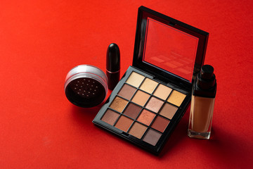Set of cosmetics isolated over red background. Close up.