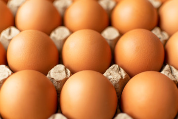 Brown egg in paper packaging. Container for eggs. Recycling. Healthy rustic breakfast