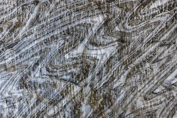 Abstract gray texture of natural, raw salt in an underground salt mine
