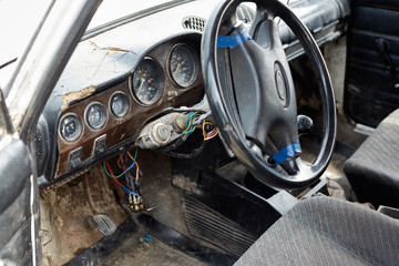 The very damaged interior of an old car from the 1980s