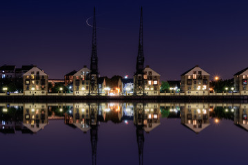 Long Exposure, Royal Victoria Dock in London at twilight with dockside cranes and waterfront houses