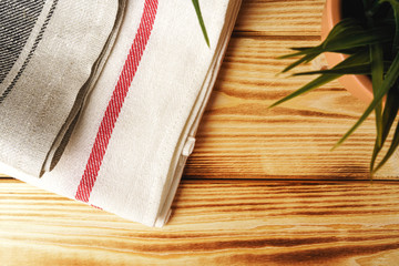 Kitchen towel or napkin over the wooden table. Close up.