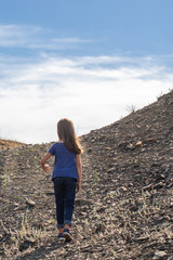 Child girl on the top of the mountain