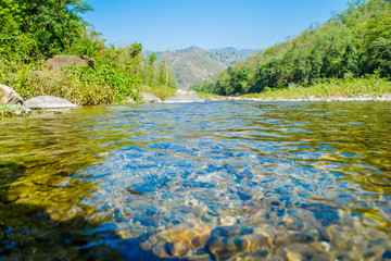 Stone under crystal clear water of  Ganga River at Rishikesh
