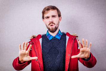 Afraid man in defense attitude gesturing stop with hands