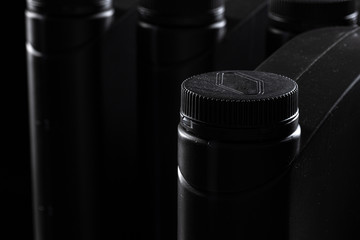 Engine oil bottle on black background.