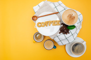 Coffee and cookies over yellow background