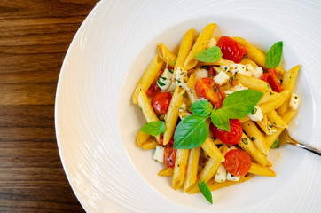 Traditional pasta made with mozarella, tomatoes and fresh basil