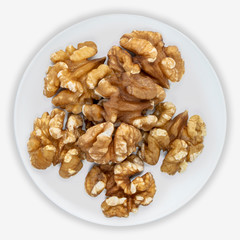 Walnuts to on a white plate. Isolated background. View from above.
