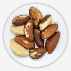 Obraz premium Brazil nuts (Bertholletia excelsa) on a white plate. Isolated background. View from above.