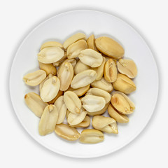 Peanuts on a white plate. Isolated background. View from above.