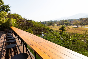 perspective wooden table floor and mountain landscape scenic at coffee shop .