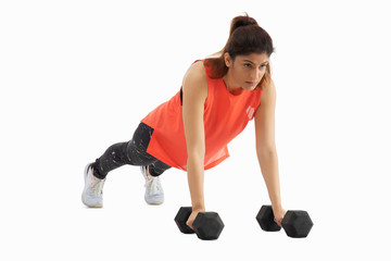 Woman doing push ups with dumbbells on a white background. 
