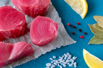tuna steaks on a blue background with spices