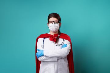 Doctor wearing surgical face mask in superhero cape.