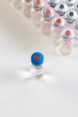 close up on vaccine and medical syringe