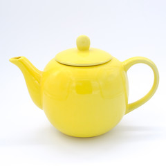Closeup Yellow teapot on white background, over light