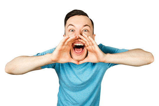 Young Screaming Guy With Open Mouth Dressed In A Blue T Shirt On A Isolated White Background. Close Up Portrait.