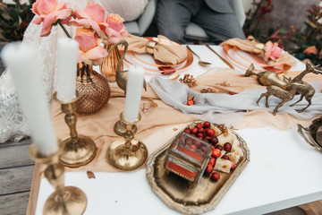 Delicate wedding decorated with pomegranate and succulent surrounded by flowers and candles