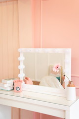 Fototapeta na wymiar pastel sweet corner for feminine vanity, makeup table and light bulb decorating on square mirror .
