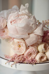 Sweet white cream cake round with pink roses flowers and white peony on top, valentine love, wedding concept.