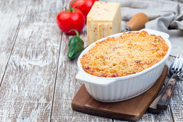 Mac and cheese with mini penne pasta, in baking dish, horizontal, copy space