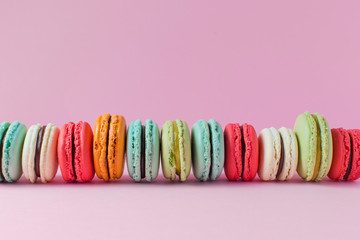 Beautiful colourful desserts. french macaroons on a pink background