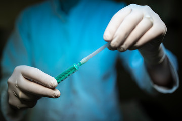 Nurse holding a Syringe and a vaccine container.