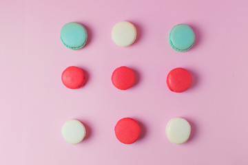 Beautiful colourful desserts. french macaroons on a pink background