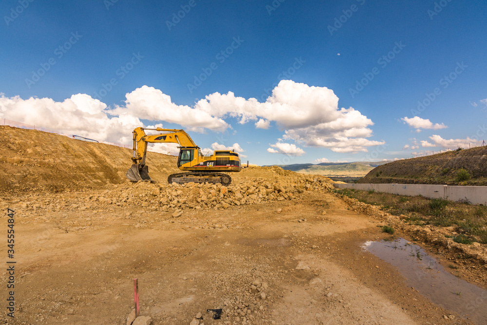 Wall mural Excavator in a quarry extracting stone