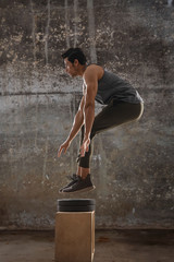 Man jumping during his intense workout. 
