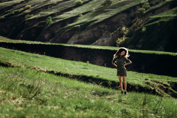 Fototapeta premium beautiful emotional girl on green saturated hills