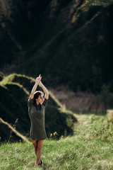 beautiful emotional girl on green saturated hills