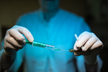 Nurse holding a Syringe and a vaccine container.