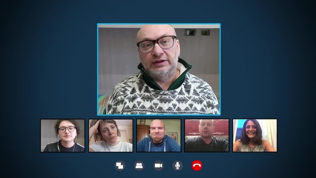 mature man in video call on skype with his young colleagues