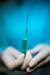 Nurse holding a Syringe and a vaccine container.