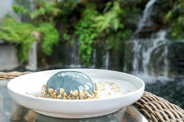 Earl Grey Mousse Cake in white plate, nature background.