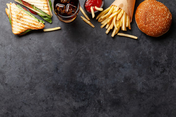 Club sandwich, potato fries, hamburger and cola