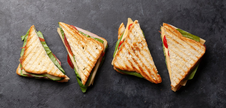 Club sandwich with ham, cheese, salad and vegetables