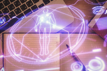 Education hologram drawings over computer on the desktop background. Top view. Multi exposure.