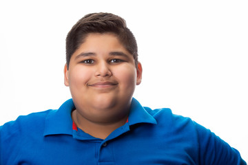Portrait of a chubby boy smiling. (Obesity) 	