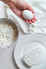 Woman making homemade cheese pancake for breakfast. Girls hands in flour. Cooking fresh healthy food. Preparation raw ingredients for baking. Chef kneading on kitchen table. Culinary work
