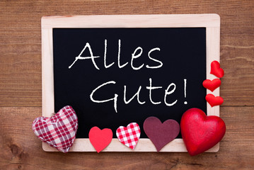 Balckboard With German Text Alles Gute Means Best Wishes. Red Heart Decoration. Brown Wooden Background