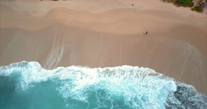 Ocean and beach without tourists. Blue ocean with big waves drone shot