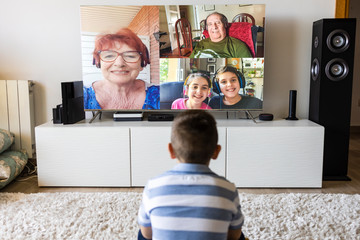 Little kid making a video call on tv