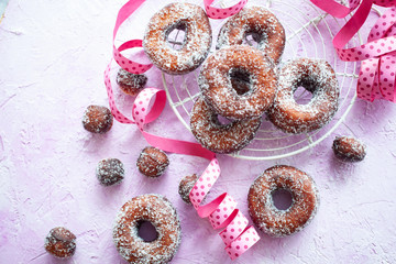 Sugar donuts on pink background - 345560296