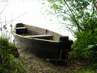    wooden boat on the lake in summertime  