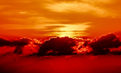 Sunset on the orange sea. Evening sky with clouds. Orange color highlights the texture of clouds and ocean. Here shows the game of the setting sun.